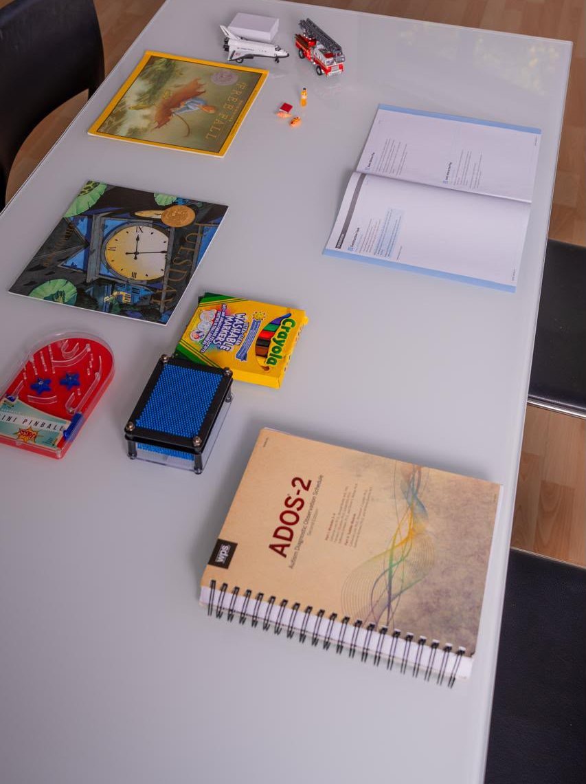 ADOS-2 assessment materials on the table